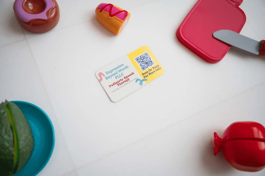Expression Beyond Words business card with pediatric therapy play materials