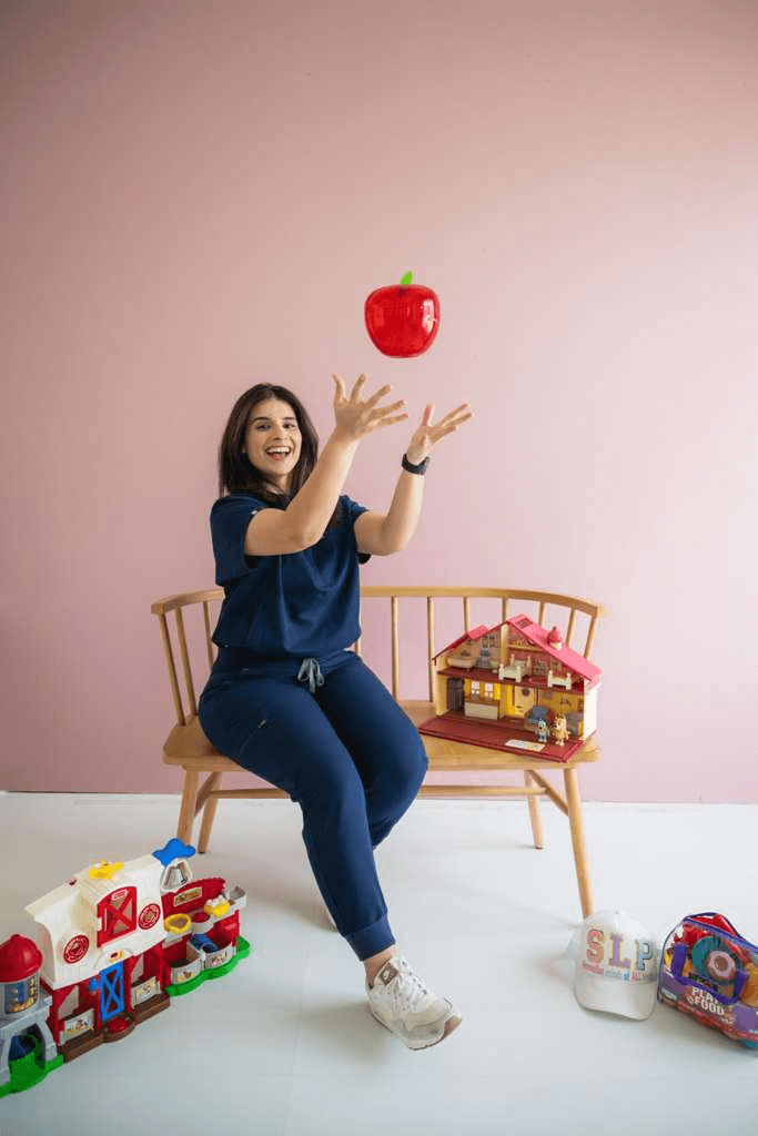 Verda, ASHA-certified speech-language pathologist, with play-based therapy toys