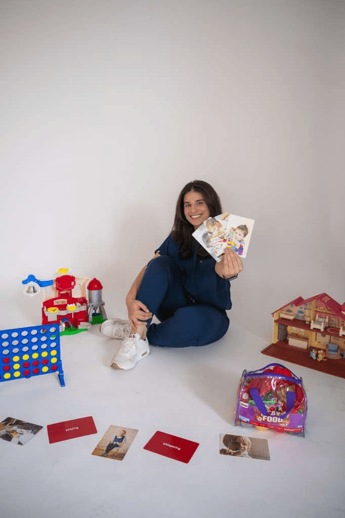 Verda with flashcards and play materials used in pediatric speech therapy
